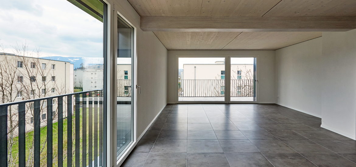 Rénovation énergétique Minergie d'un immeuble locatif des années 80 à Fribourg avec extension en bois