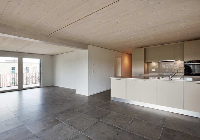 Rénovation énergétique Minergie d'un immeuble locatif des années 80 à Fribourg avec extension en bois